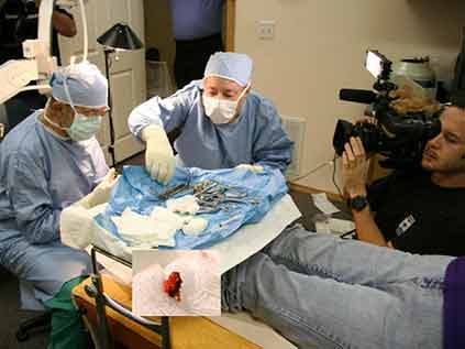 Doctors Being Video Recorded Performing Surgery